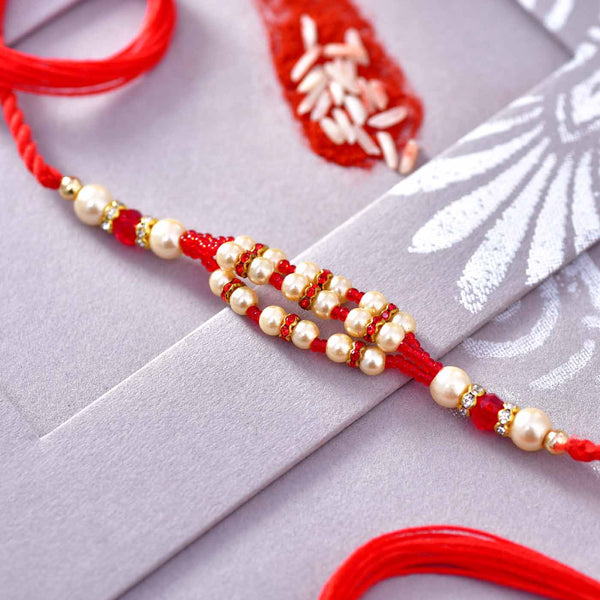 Fascinating Pearls & Red Beads Rakhi