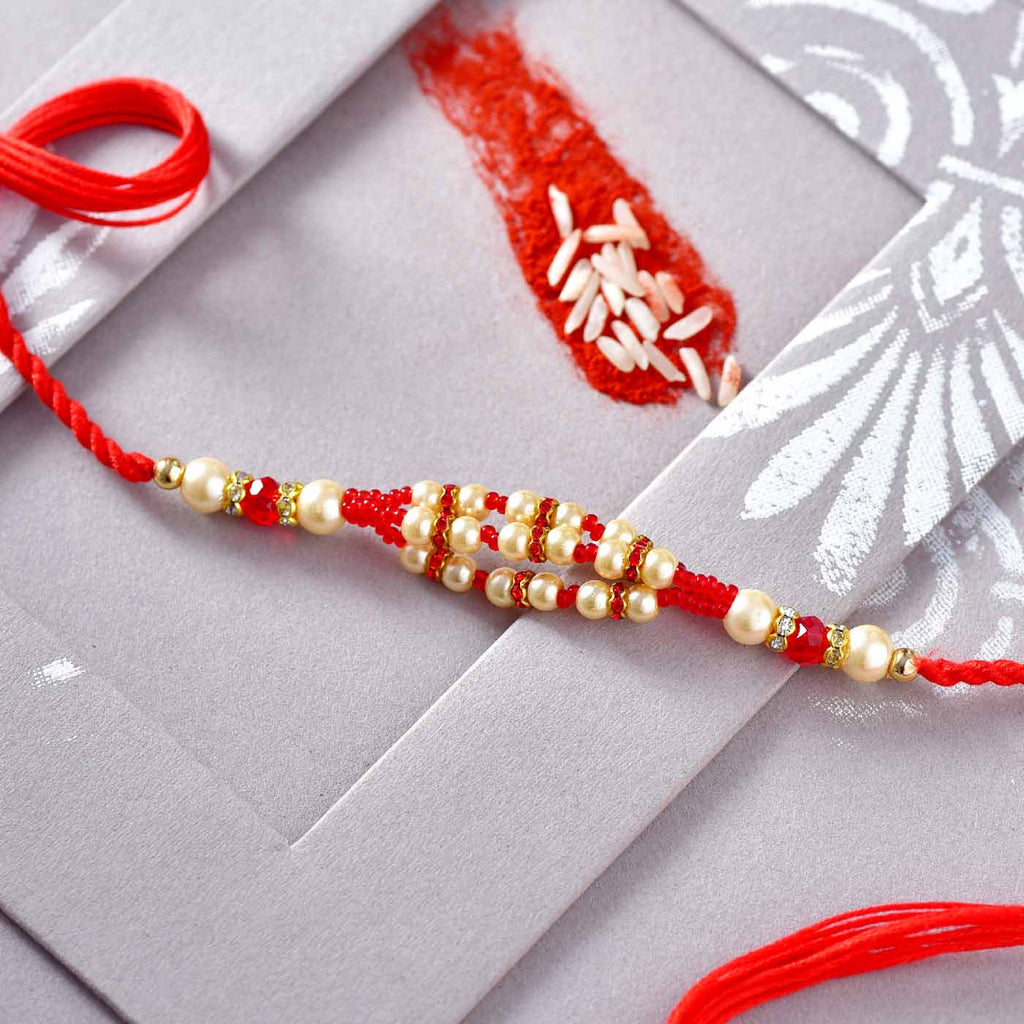 Fascinating Pearls & Red Beads Rakhi
