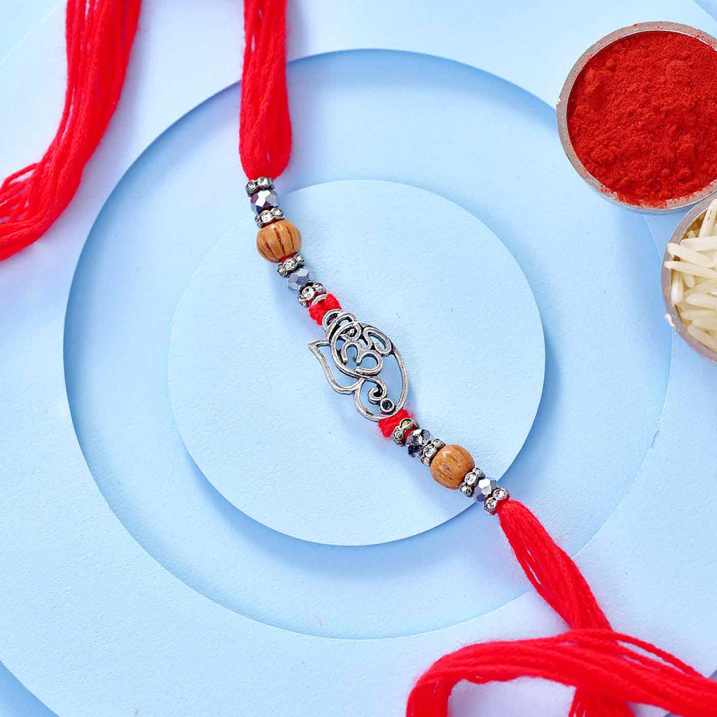 Traditional Om-Ganesha And Pearls Rakhi On Red Mauli