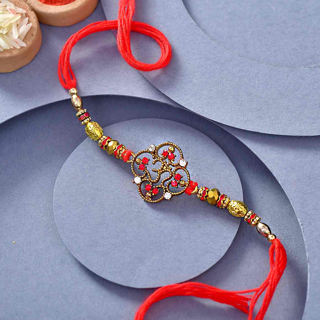 Floral Pattern Om Rakhi With Wooden & Red Beads