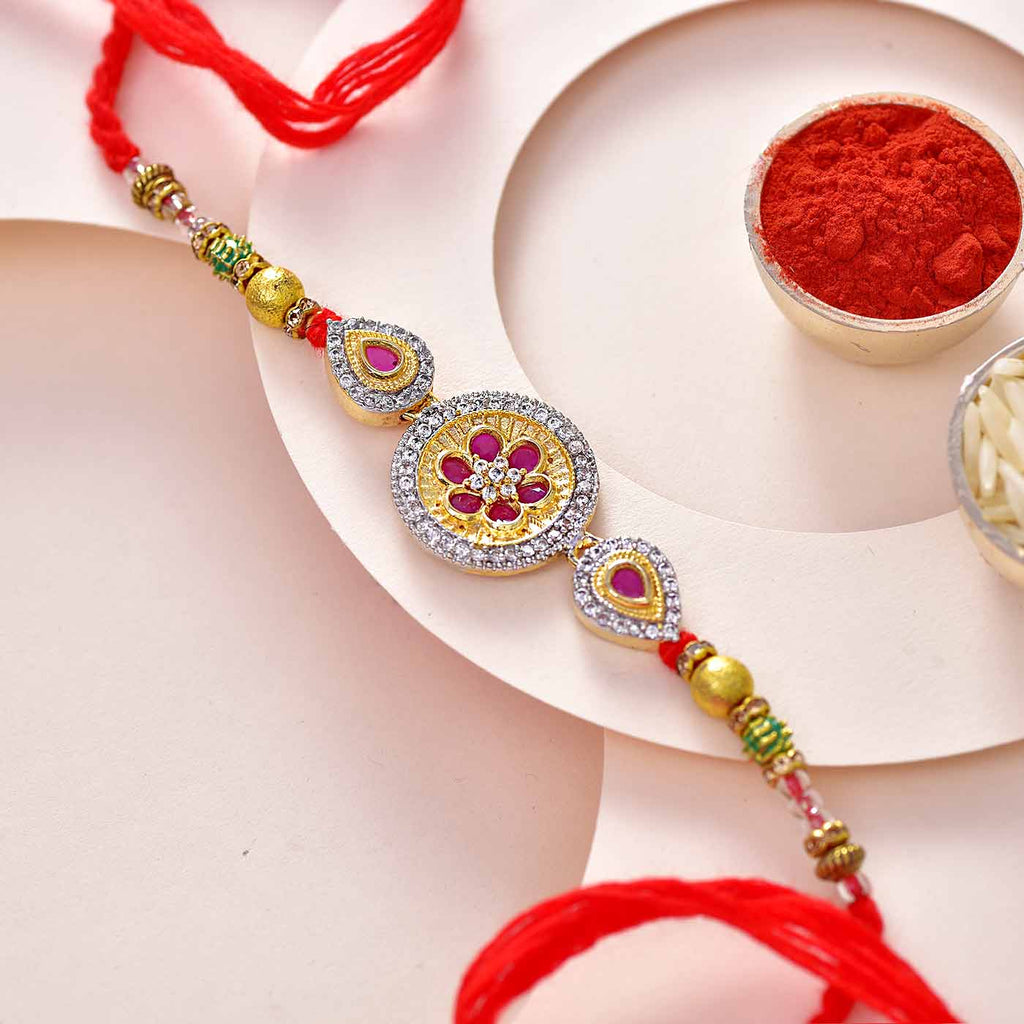 Stone Studded Floral Dial Rakhi With Beads Work