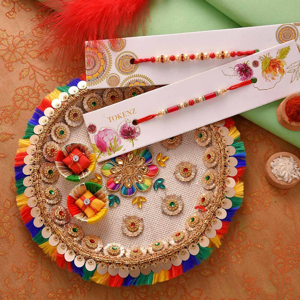 Beautiful Set Of 2 Pearls Rakhi With Colourful Thali